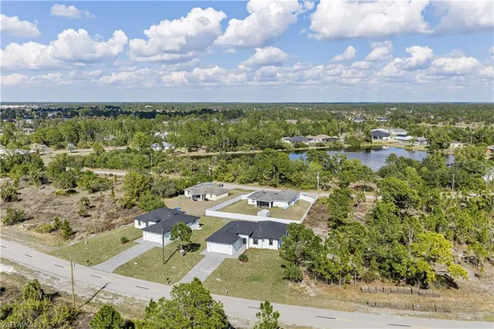 Drone / aerial view of a tree filled landscape and a large body of water