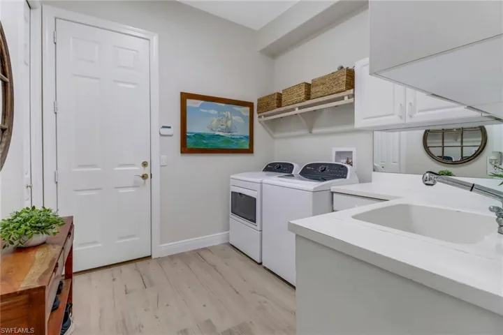 Spacious laundry room and ample counter space with cabinets.
