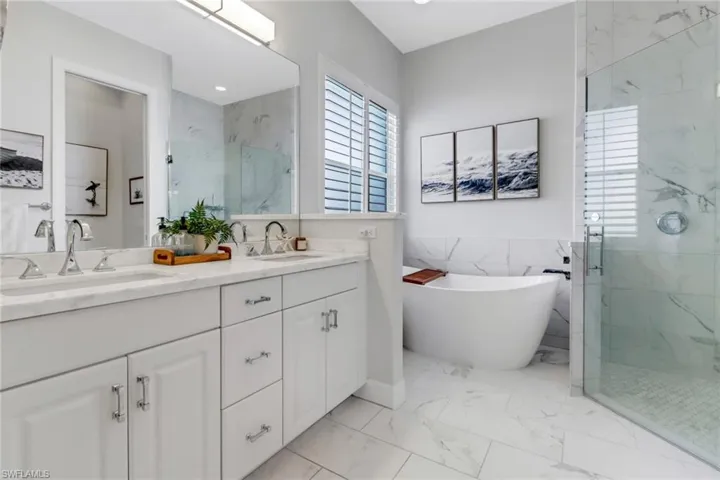 Fully updated primary bathroom with Luxurious soaking tub and private glass shower.
