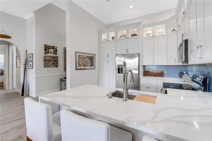 Fully updated kitchen with Quartz countertops with waterfall and eat in bar.