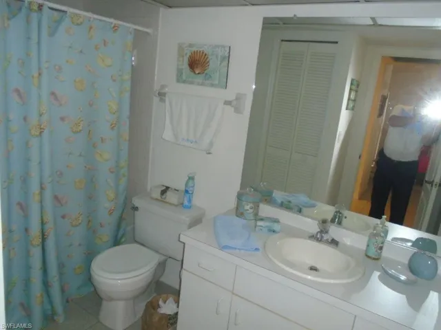 Bathroom featuring tile floors, toilet, and oversized vanity