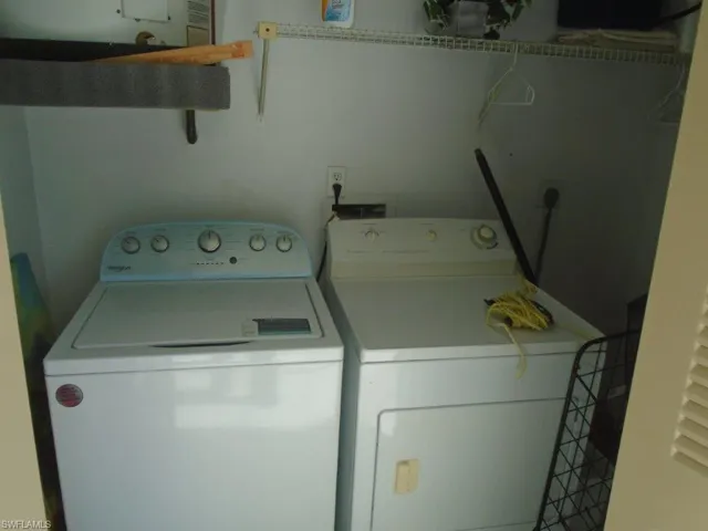 Clothes washing area featuring washing machine and dryer
