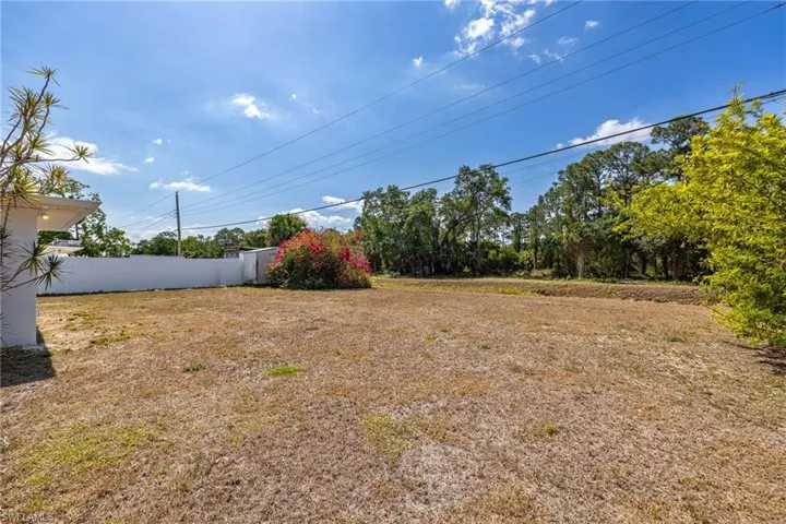 View of yard featuring fence