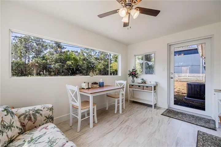 Dining space featuring baseboards, marble finish floor, and ceiling fan