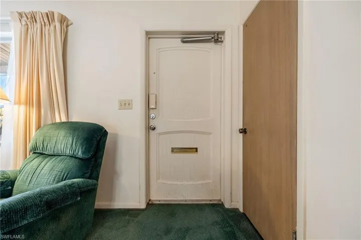 Entryway with dark carpet