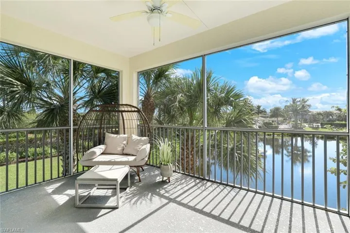 Sunroom / solarium featuring a water view