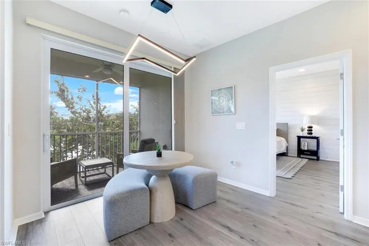 Dining space with light wood-style floors, a ceiling fan, and a sunroom