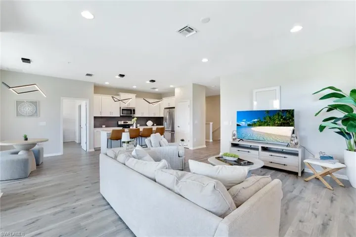Living room with recessed lighting and light wood-style flooring