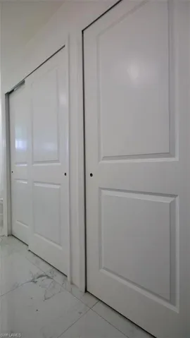 White panel doors with polished porcelain tile flooring