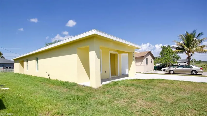 Single-story yellow exterior structure with a white trim roofline