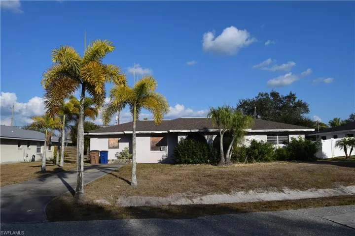 Single story home featuring driveway and stucco siding