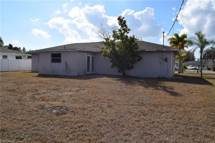 Rear view of house featuring a patio area, stucco siding, and french doors