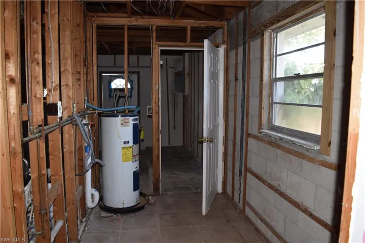 Utility room featuring electric water heater