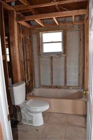 Full bathroom with toilet and shower / washtub combination