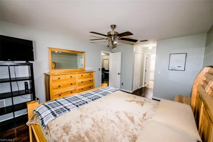 Bedroom with dark wood-style flooring and ceiling fan