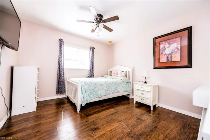 Bedroom with wood finished floors and ceiling fan
