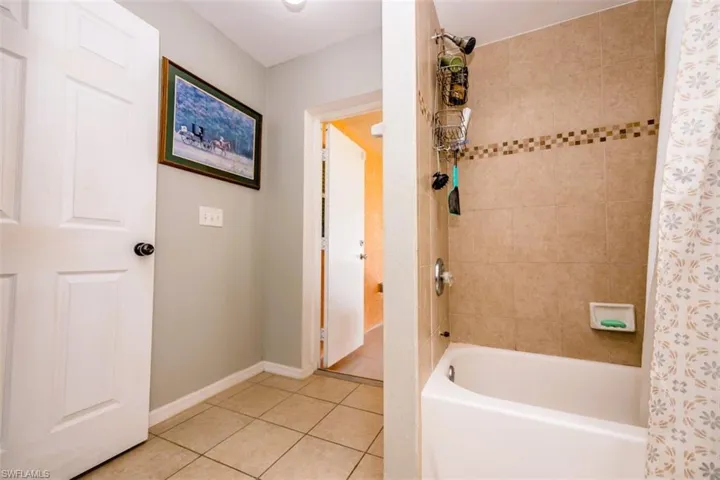 Full bathroom with tile patterned flooring and shower / bath combo