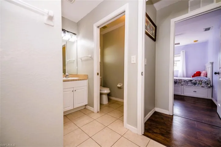 Ensuite bathroom with vanity and tile patterned floors