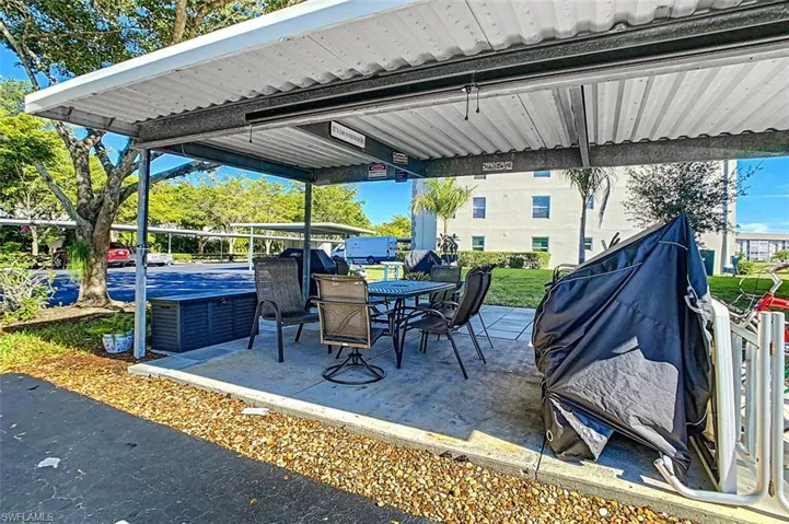 View of patio with outdoor dining space and grilling area