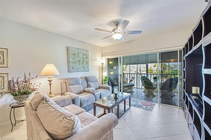 Living room featuring ceiling fan and light tile patterned flooring