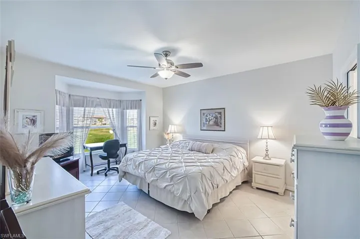 Bedroom with light tile patterned flooring and a ceiling fan