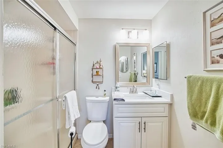Full bathroom featuring vanity and a stall shower