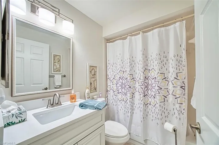 Bathroom with vanity and shower / bath combination with curtain
