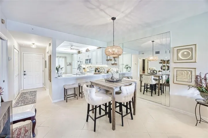 Dining space featuring a ceiling fan and light tile patterned flooring