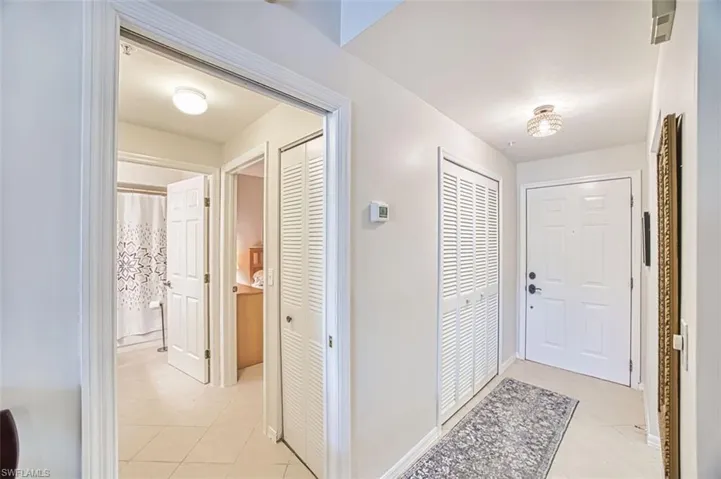 Foyer entrance featuring light tile patterned floors