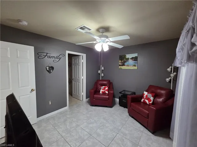 Flex/den room with a ceiling fan and light tile floors