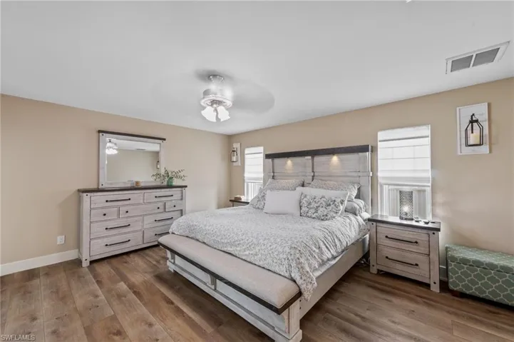 Bedroom featuring dark wood-style floors and ceiling fan