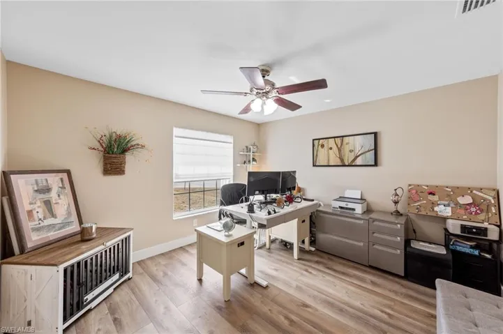 Office space featuring light wood finished floors and a ceiling fan