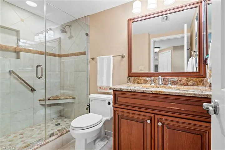Bathroom featuring a stall shower and vanity