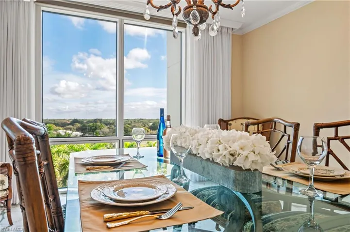Dining room with a chandelier and crown molding