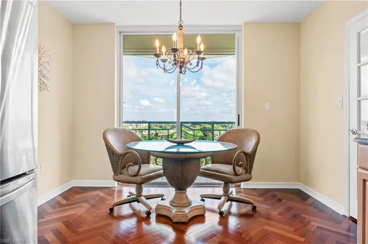 Eat-in Kitchen Dining area featuring a chandelier and expansive windows
