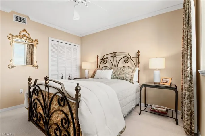 Bedroom featuring crown molding, carpet flooring, ceiling fan, and a closet