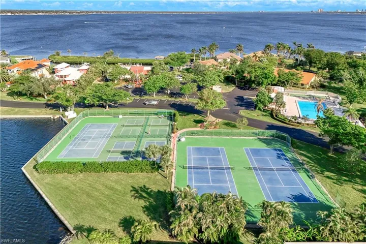 Birds eye view of property with a water view