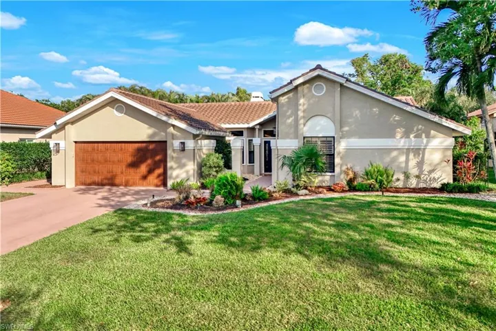 View of front of home featuring a garage and a front yard