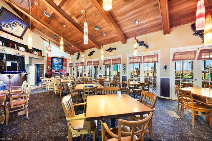 Dining area featuring beam ceiling, high vaulted ceiling, french doors, and wooden ceiling