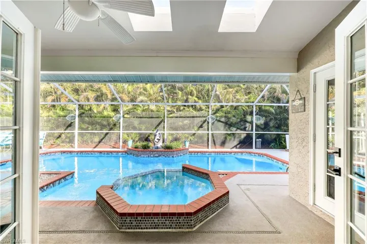 View of pool with ceiling fan and a patio area