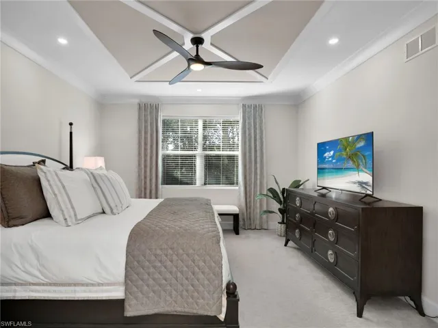 Bedroom with light carpet, crown molding, and ceiling fan