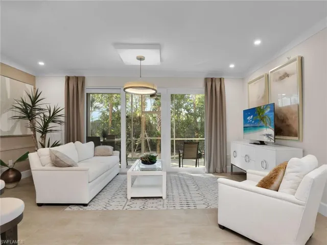 Living room featuring light tile patterned floors and plenty of natural light