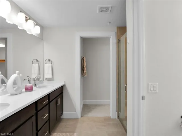 Bathroom featuring walk in shower and vanity