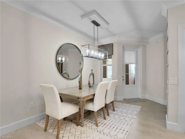 Dining space featuring crown molding and a notable chandelier