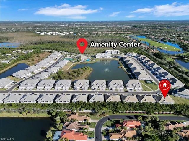 Birds eye view of property with a water view