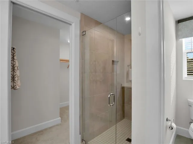Bathroom with toilet and an enclosed shower