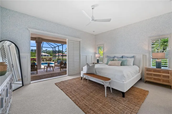 Spacious primary suite with private access to the lanai and pool