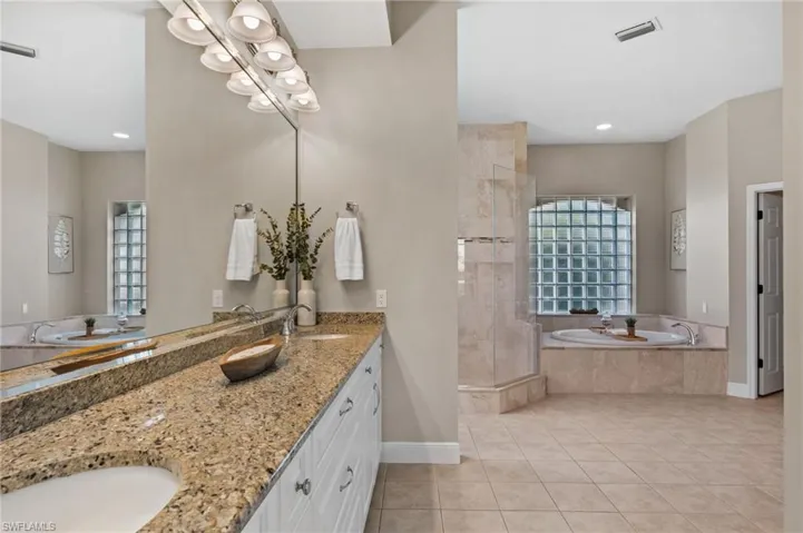 Spa-inspired primary bath with soaking tub and walk-in shower