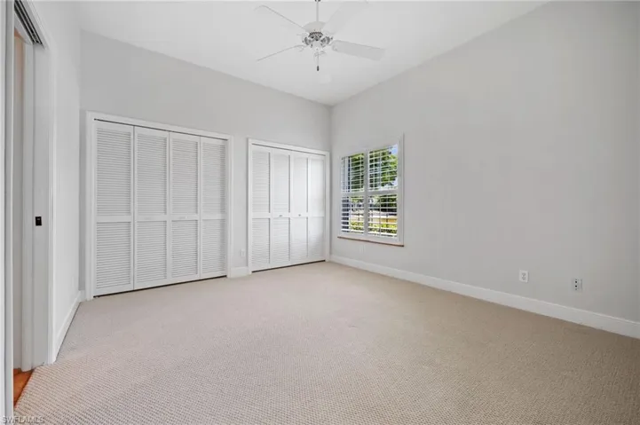 Bright guest bedroom with natural light and neutral finishes
