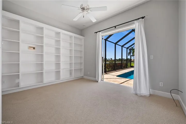 Guest bedroom with direct access to the screened lanai and pool